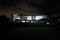 Building with scaffolding at night, lit up by the LED site light